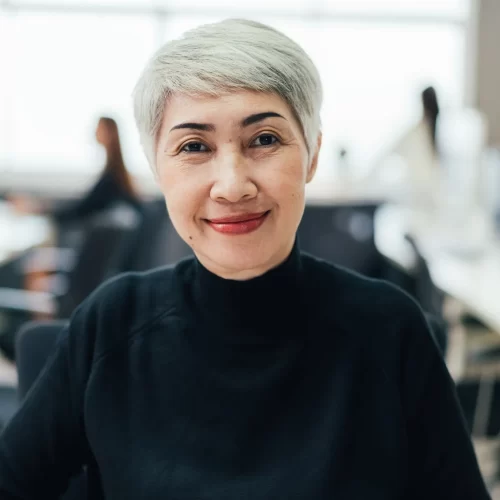 portrait-of-asian-senior-female-manager-at-desk-in-the-office